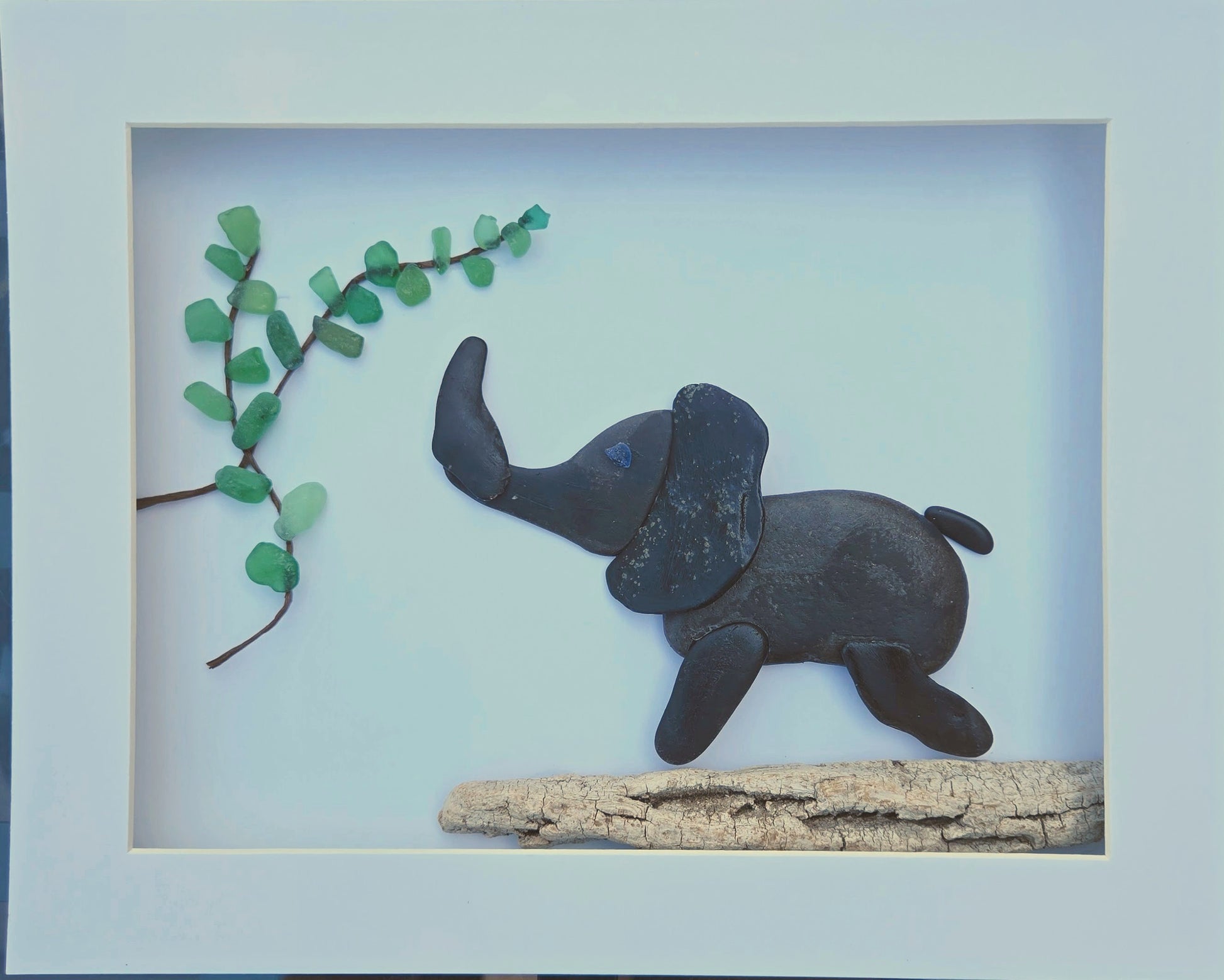 elephant made from stones and sea glass.  peblle art elephant.