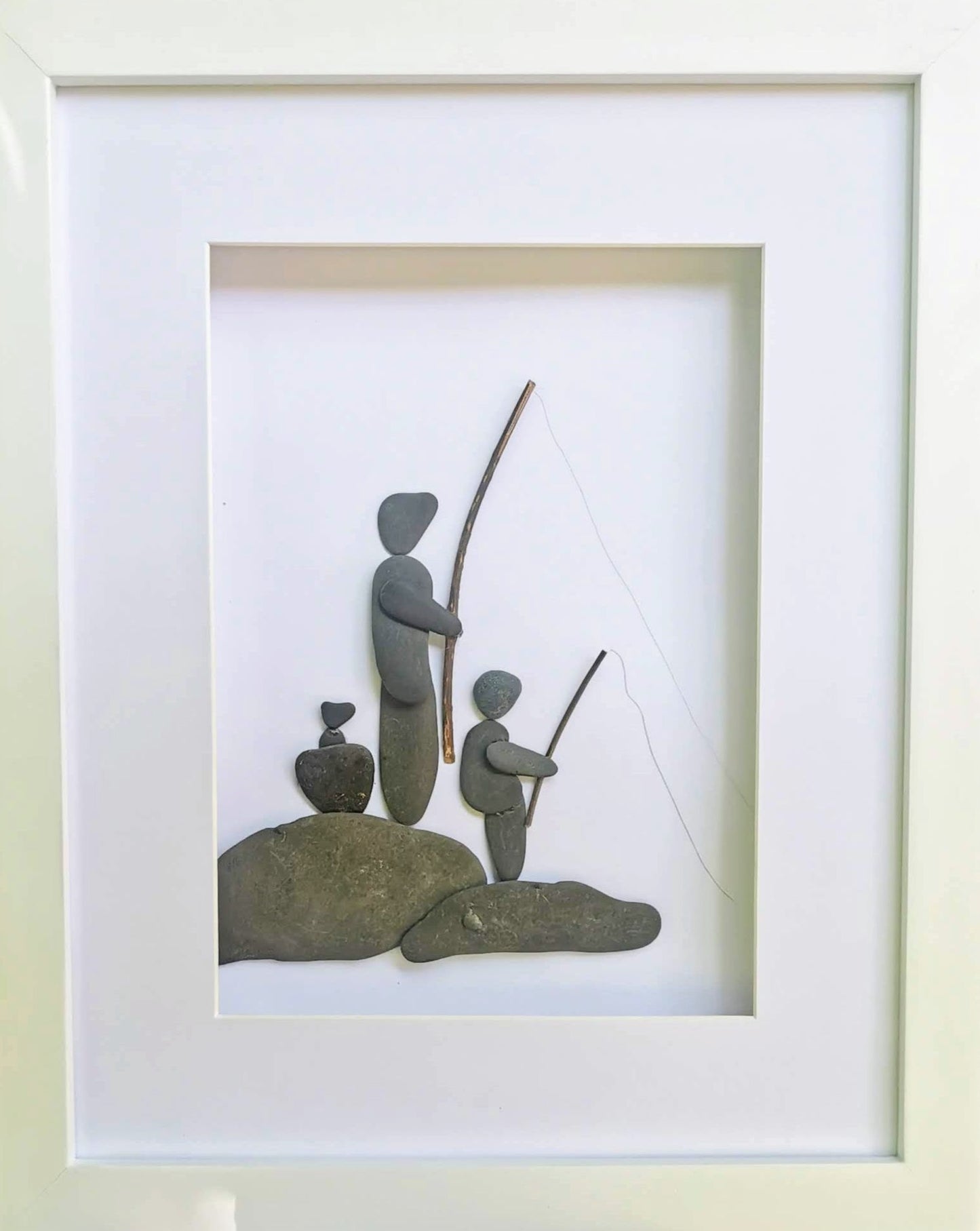 Son and dad fishing. Pebble art